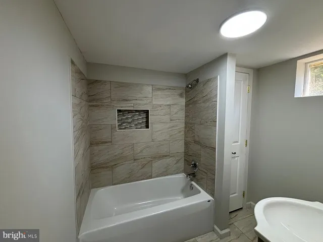 a bathroom with a bathtub and shower