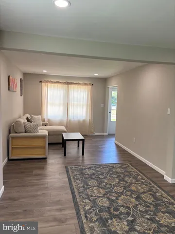 a living room with furniture and a rug