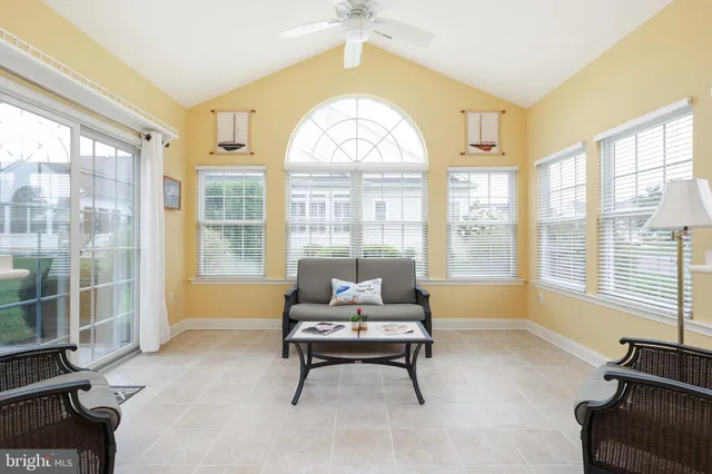 a living room with furniture and a floor to ceiling window