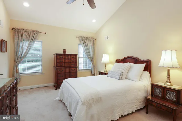 a bedroom with a bed dresser and a window