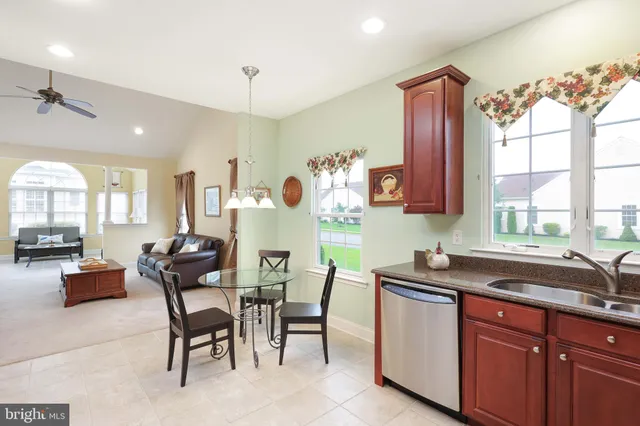 a kitchen that has a cabinets counter space dining table and a large window
