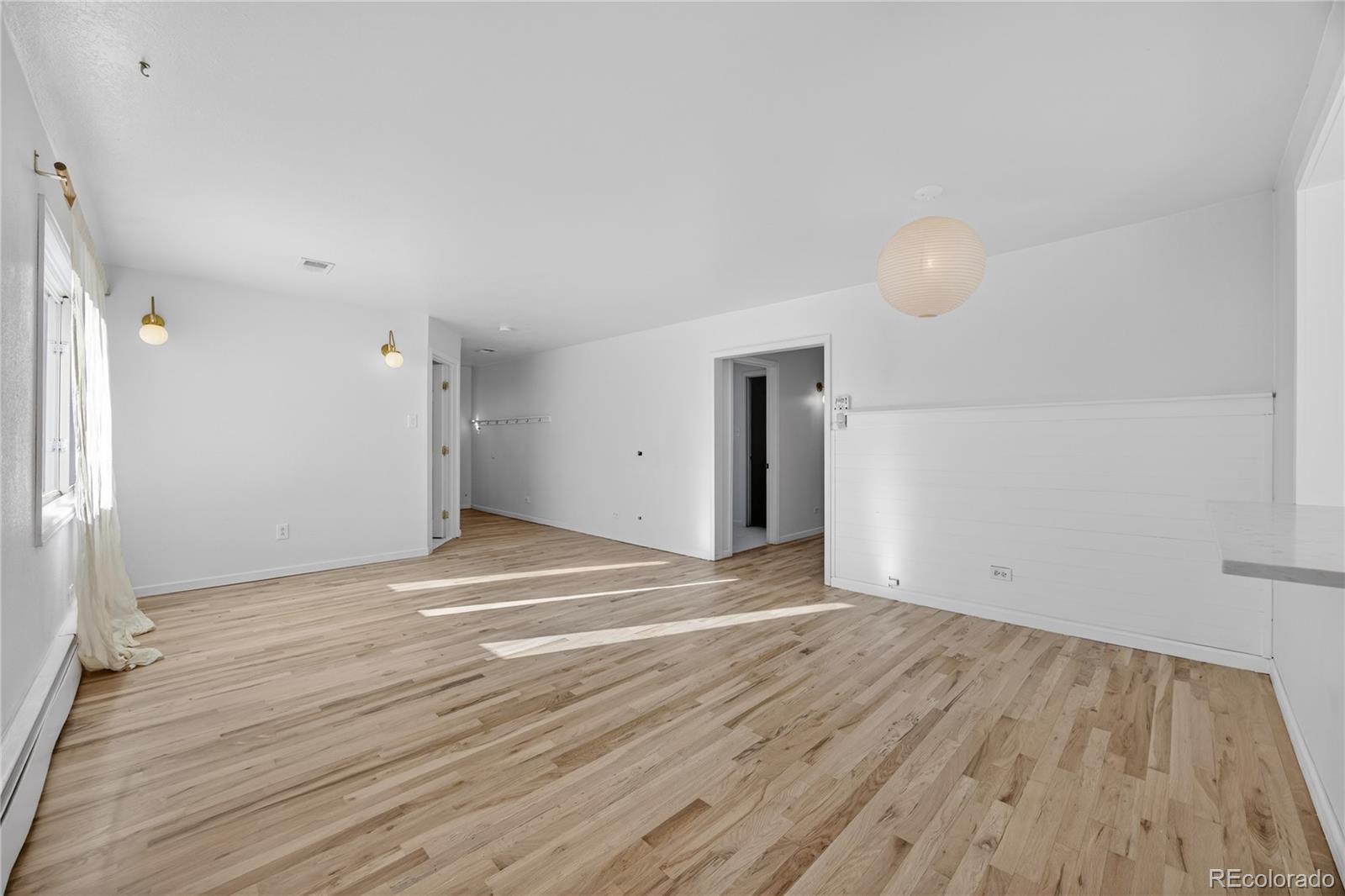 2375 Hanover Street Aurora, CO 80010 - Photo 13 of 36 a view of an empty room with wooden floor