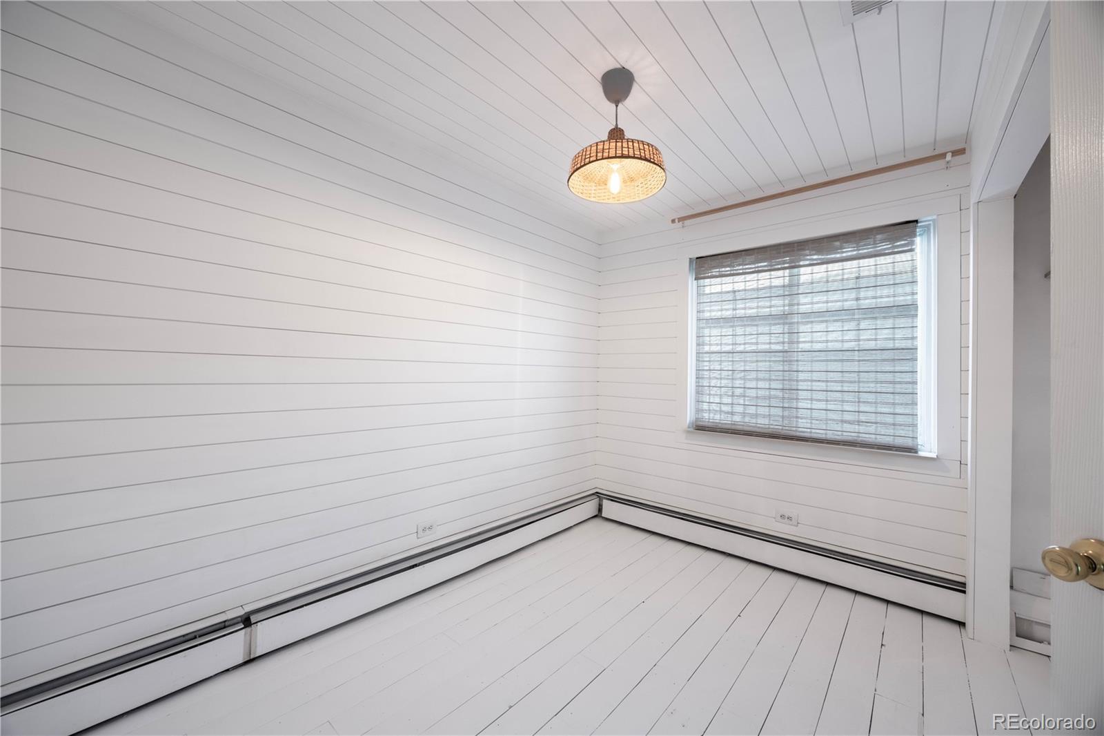 2375 Hanover Street Aurora, CO 80010 - Photo 16 of 36 a view of a room with wooden floor and a window