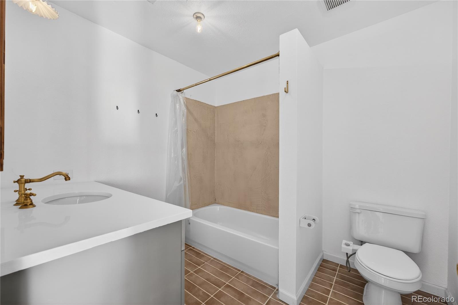 2375 Hanover Street Aurora, CO 80010 - Photo 17 of 36 a bathroom with a sink toilet and shower