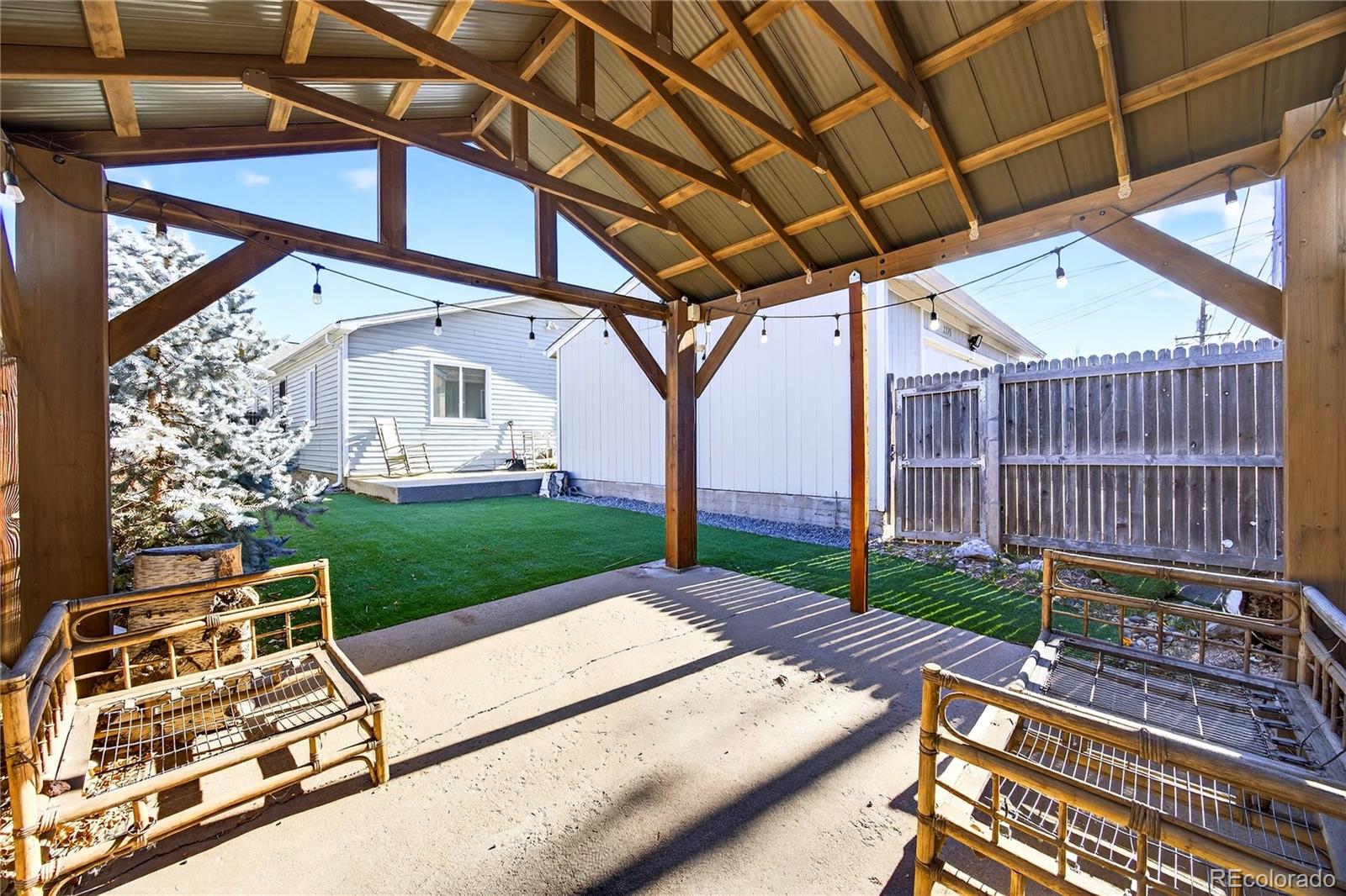 2375 Hanover Street Aurora, CO 80010 - Photo 26 of 36 a view of patio with a table and chairs and wooden fence