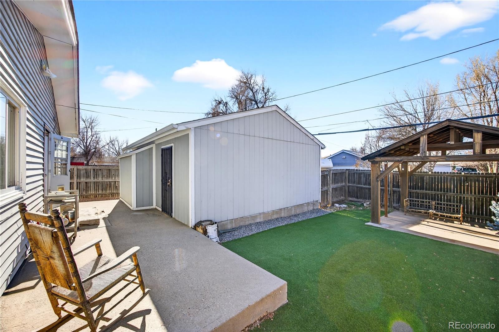 2375 Hanover Street Aurora, CO 80010 - Photo 27 of 36 a view of a backyard with table and chairs and potted plants