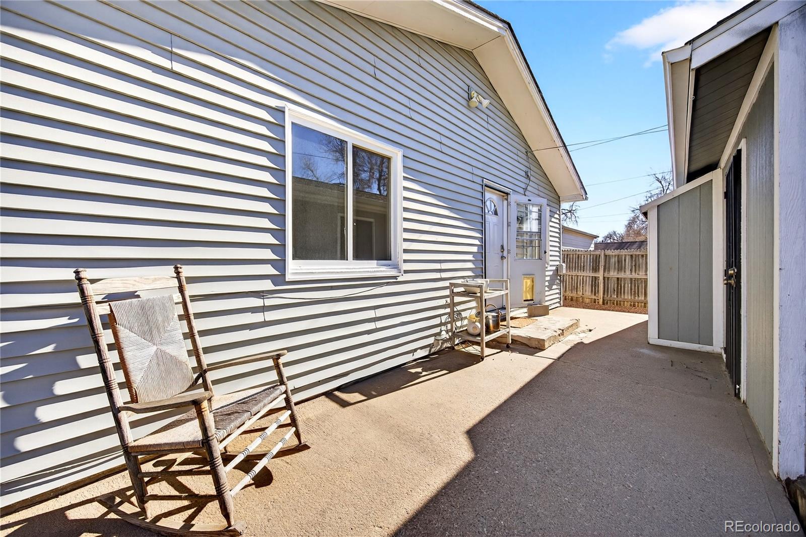 2375 Hanover Street Aurora, CO 80010 - Photo 30 of 36 a view of a house with a patio and a yard