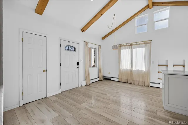 a view of a livingroom with wooden floor and window