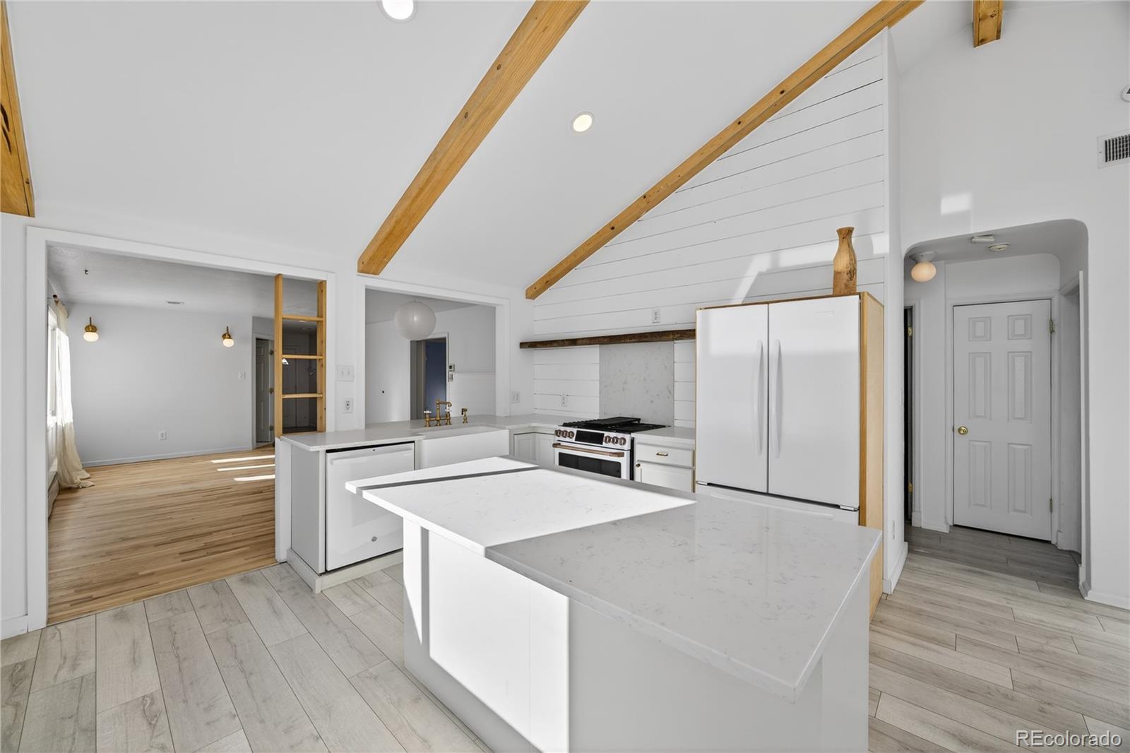 2375 Hanover Street Aurora, CO 80010 - Photo 4 of 36 a kitchen with stainless steel appliances a refrigerator and a stove