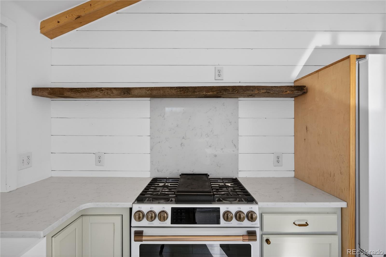 2375 Hanover Street Aurora, CO 80010 - Photo 7 of 36 a stove top oven sitting inside of a kitchen
