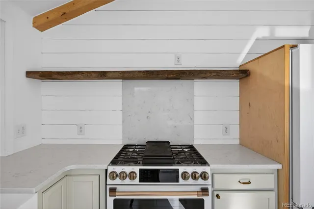 a stove top oven sitting inside of a kitchen