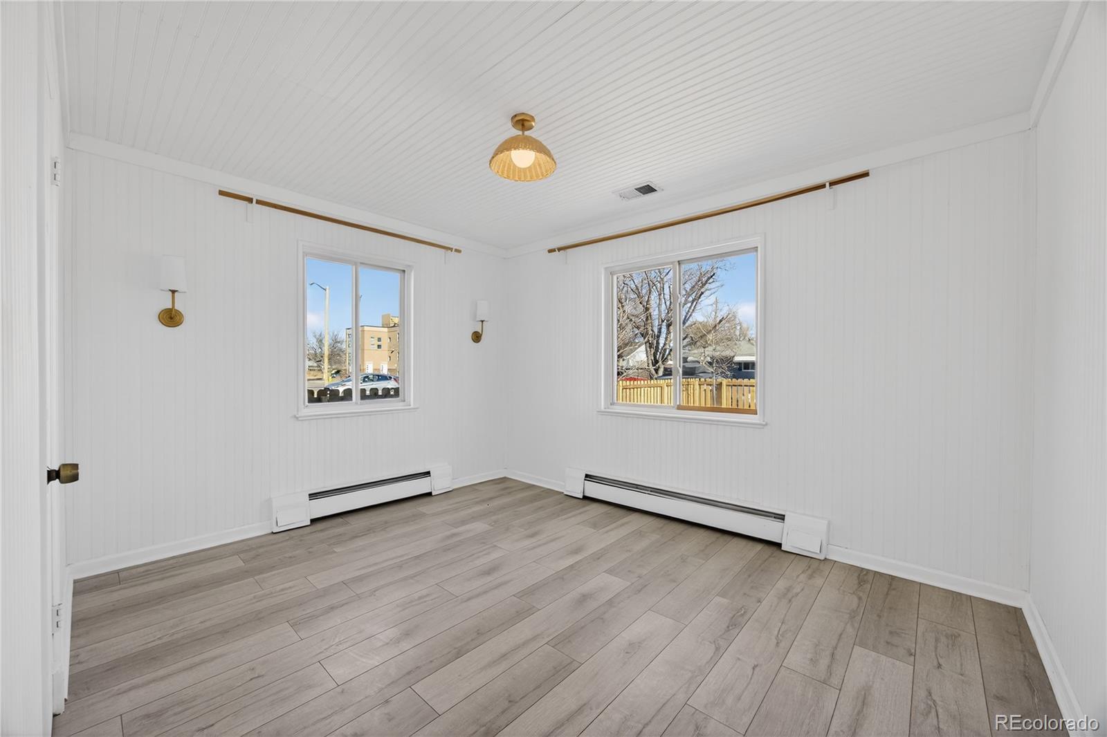 2375 Hanover Street Aurora, CO 80010 - Photo 10 of 36 an empty room with wooden floor and window