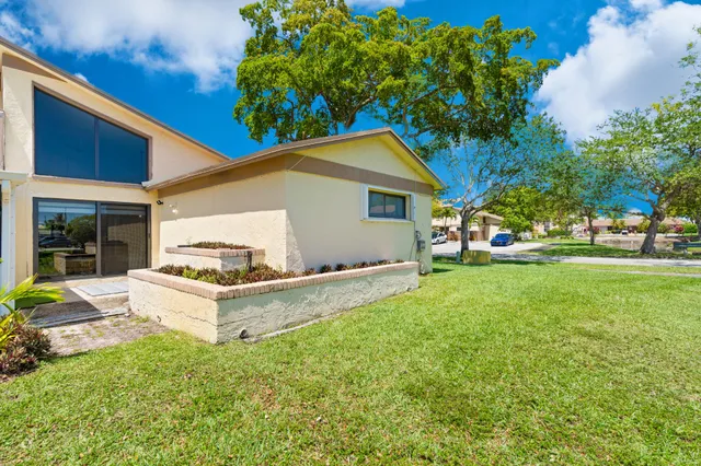 a view of an house with backyard space and garden