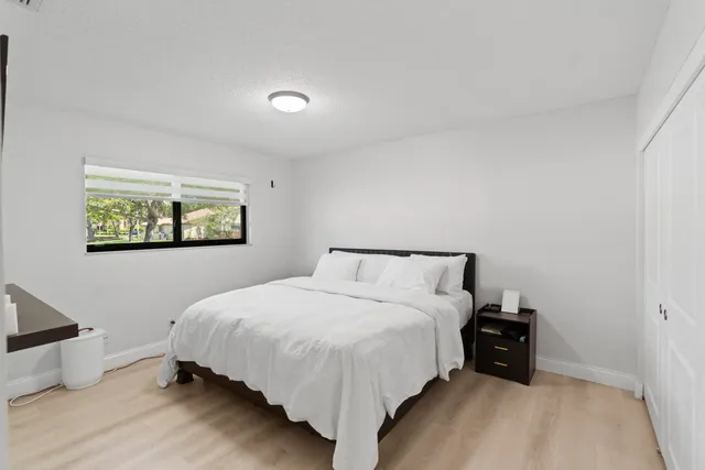 a bed room with a bed and a night stand