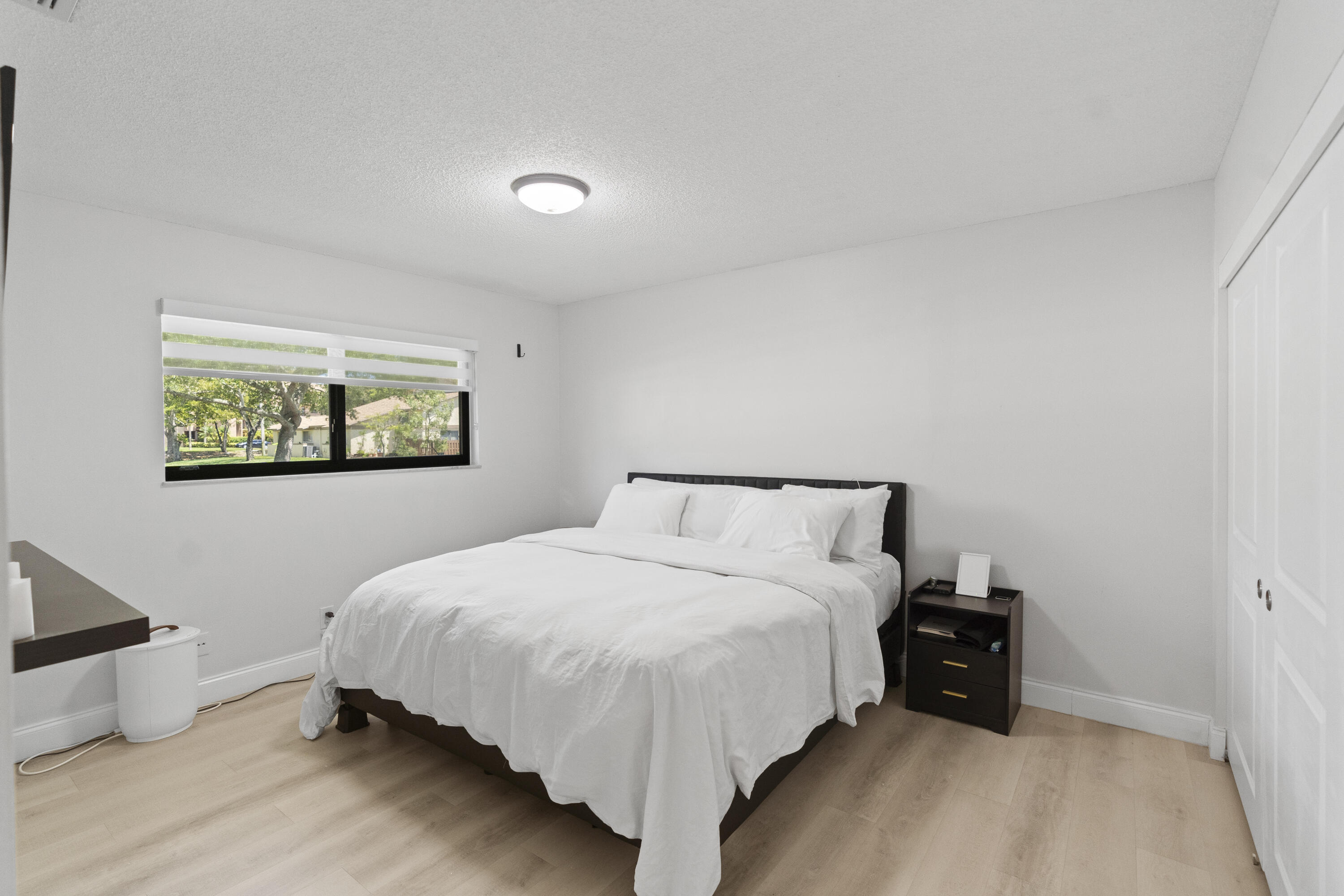 10650 Northwest 30th Place, Unit 1 Sunrise, FL 33322 - Photo 16 of 38 a bed room with a bed and a night stand