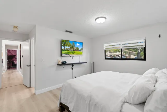 a bedroom with a bed and a tv