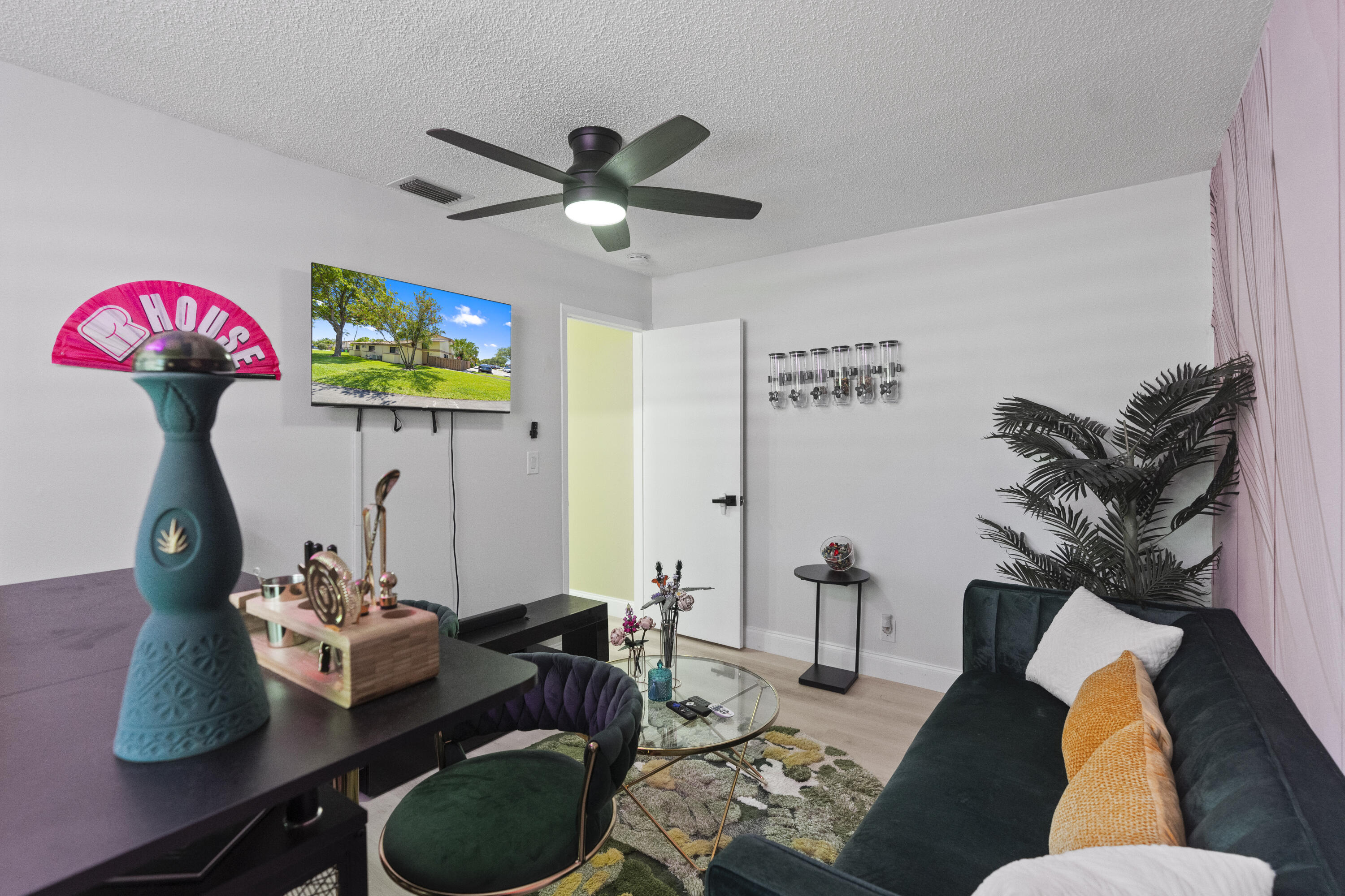 10650 Northwest 30th Place, Unit 1 Sunrise, FL 33322 - Photo 22 of 38 a living room with furniture and a chandelier