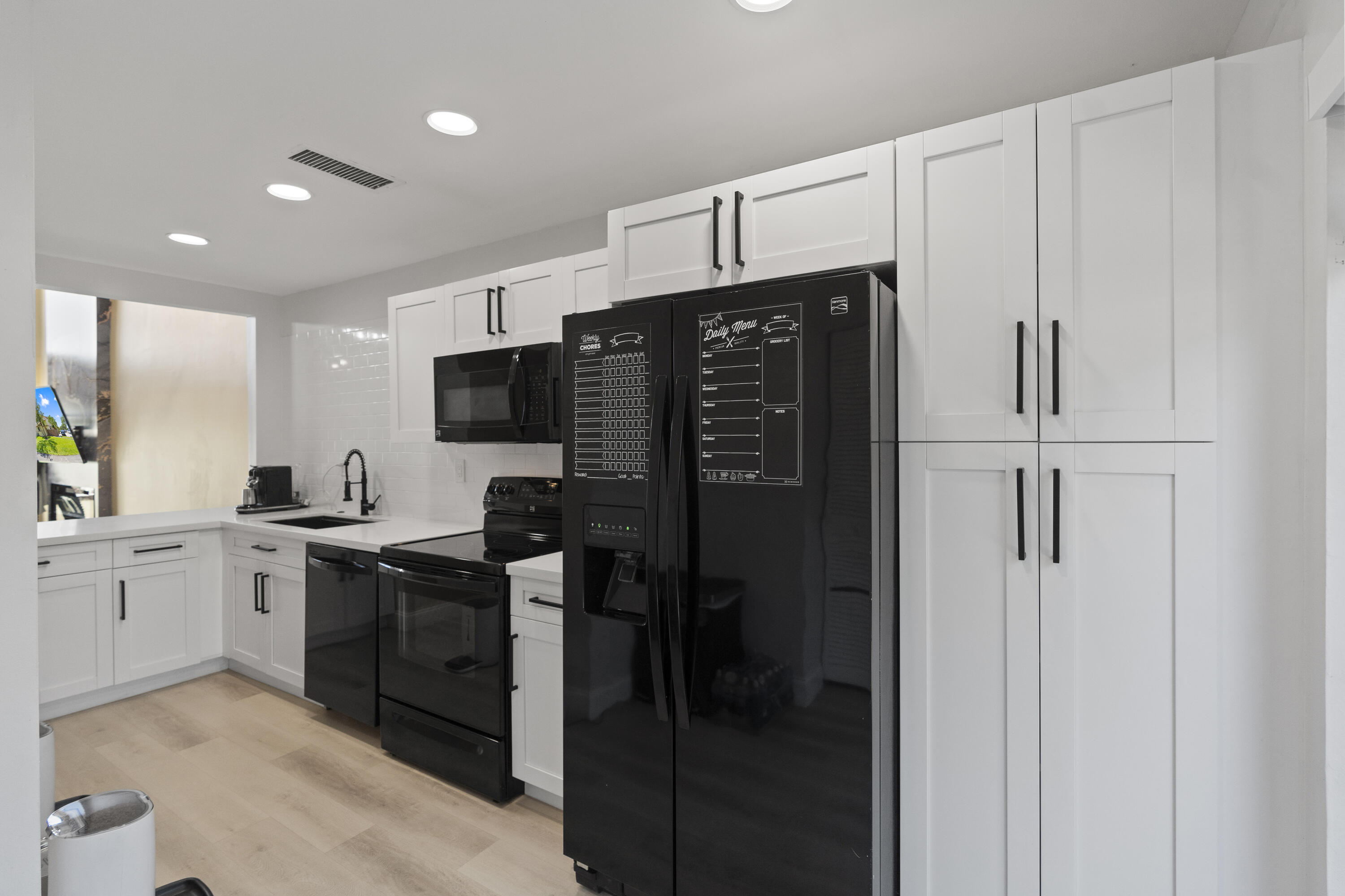 10650 Northwest 30th Place, Unit 1 Sunrise, FL 33322 - Photo 10 of 38 a kitchen with stainless steel appliances granite countertop a refrigerator and a stove top oven