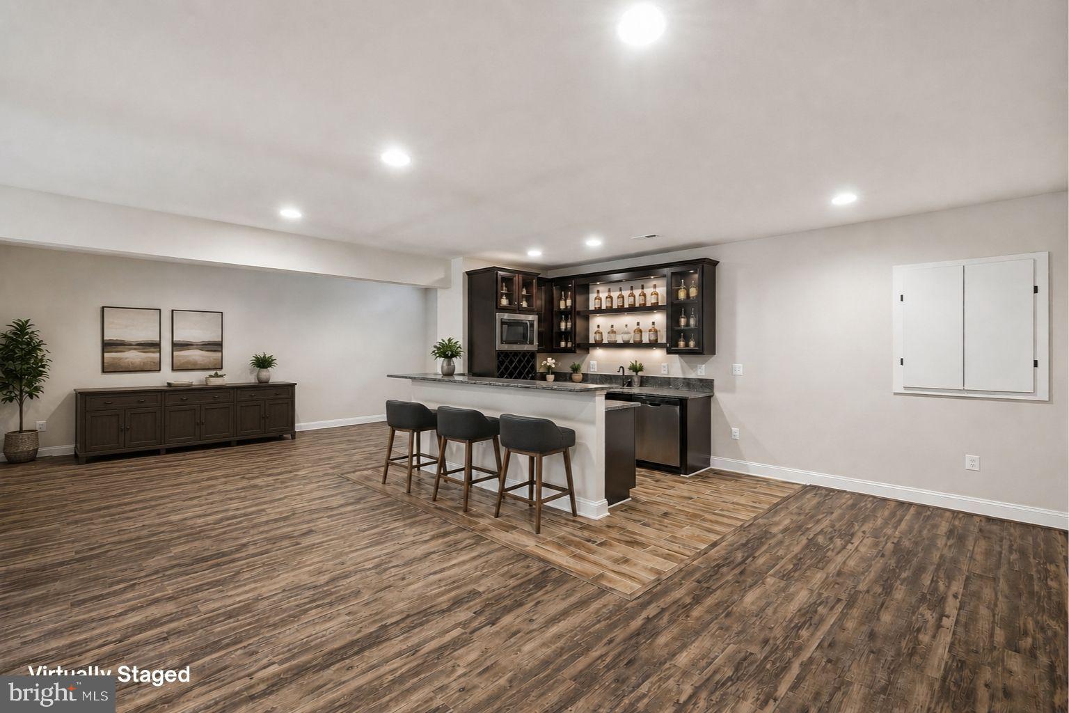7821 Old Falls Road McLean, VA 22102 - Photo 43 of 62 a living room with stainless steel appliances kitchen island granite countertop furniture and wooden floor