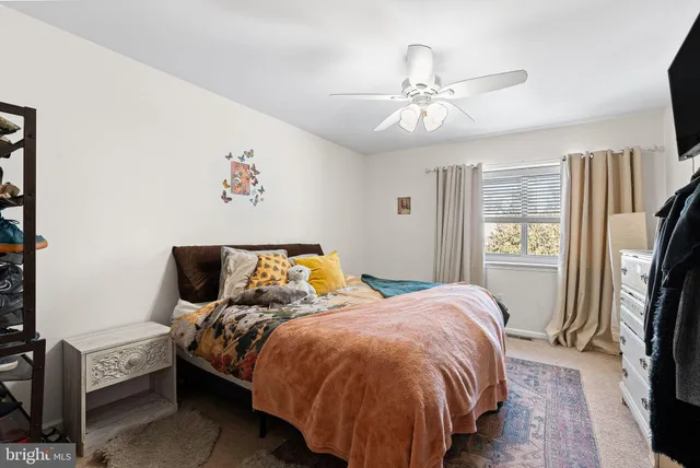 a bed sitting in a bedroom next to a window