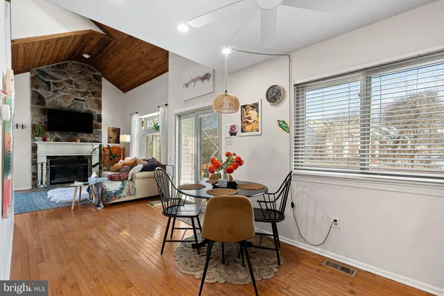 a view of a livingroom with furniture a flat screen tv and wooden floor