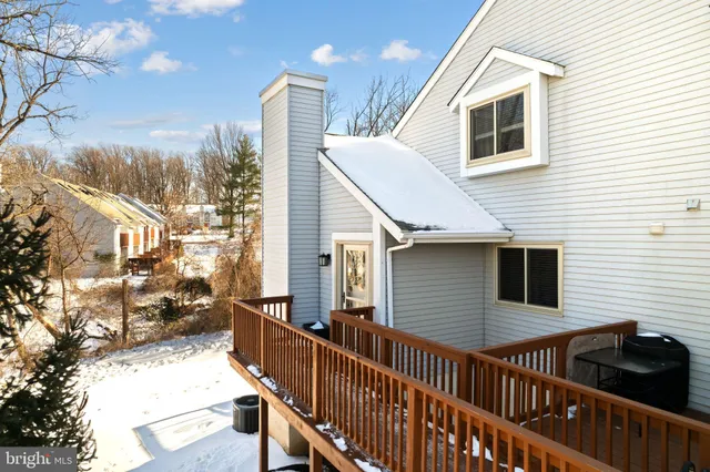 a view of a house with wooden fence