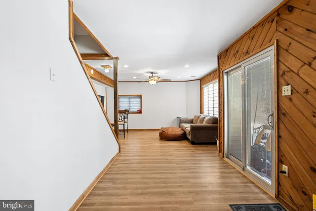 a hallway with a couch and stairs