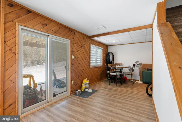 a dining room with furniture and wooden floor