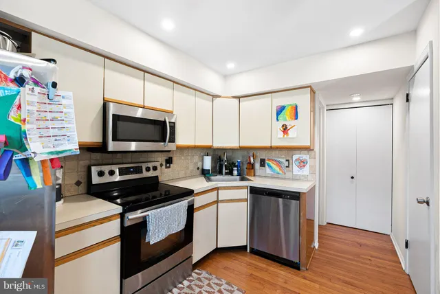 a kitchen with stainless steel appliances a stove microwave and a refrigerator