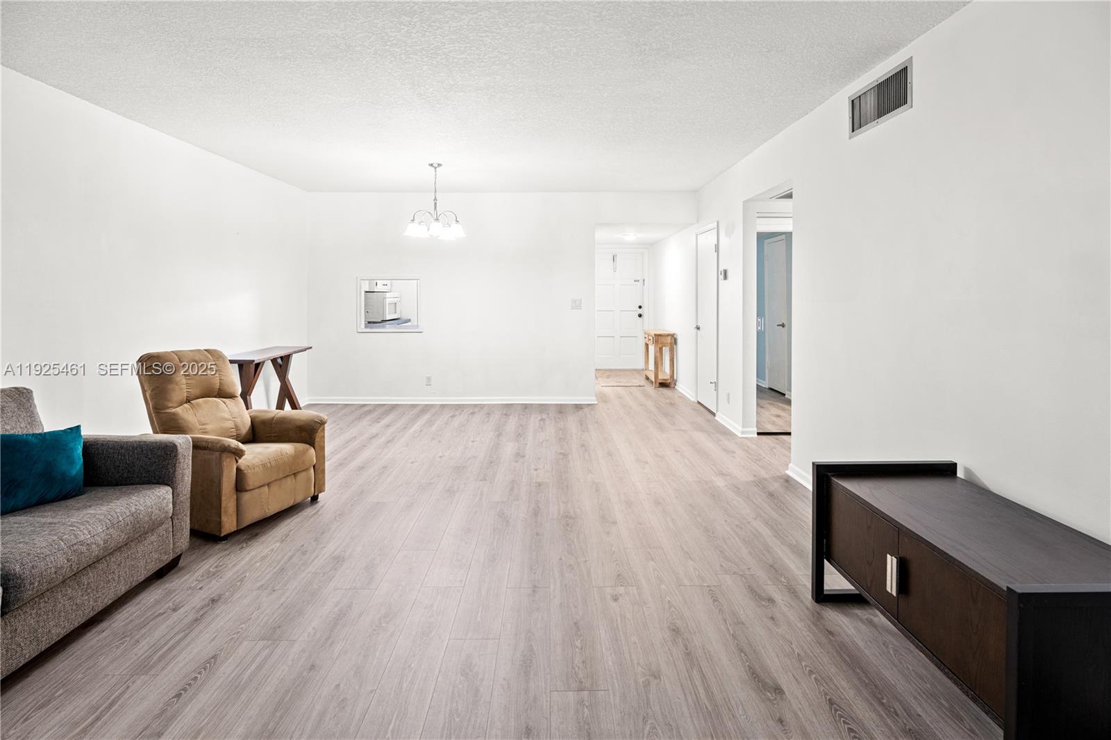 6751 Cypress Road, Unit 207 Plantation, FL 33317 - Photo 12 of 20 a living room with furniture and a wooden floor