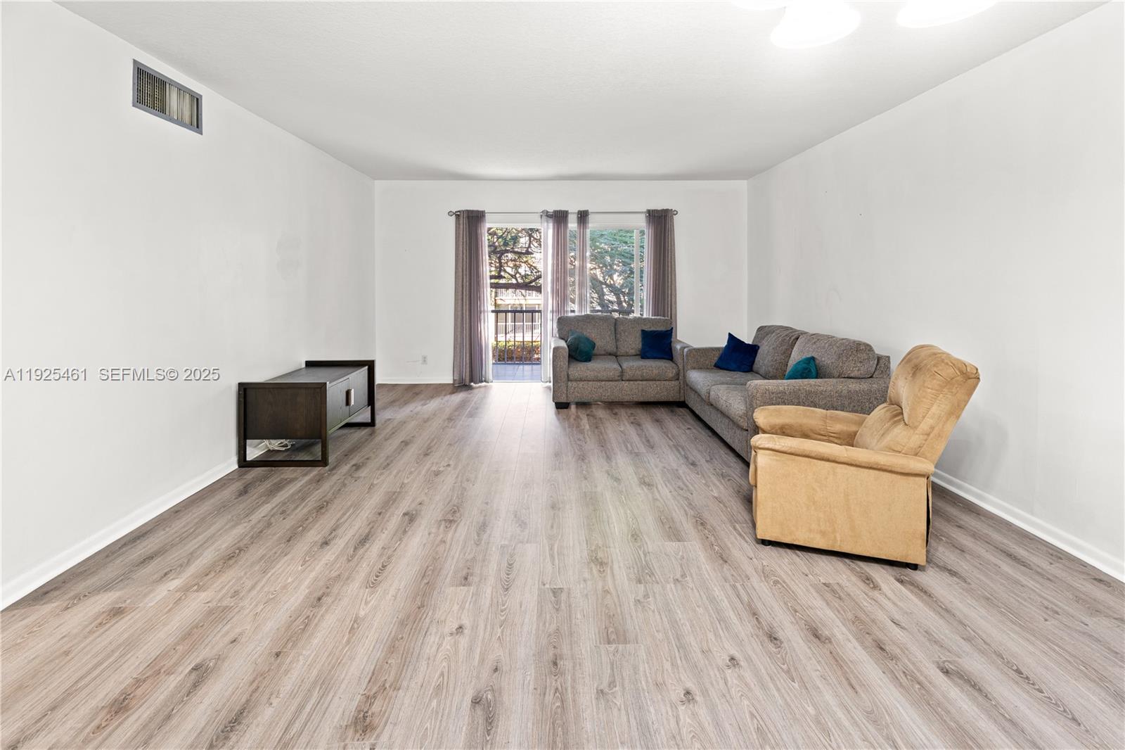 6751 Cypress Road, Unit 207 Plantation, FL 33317 - Photo 19 of 20 a living room with furniture and a wooden floor