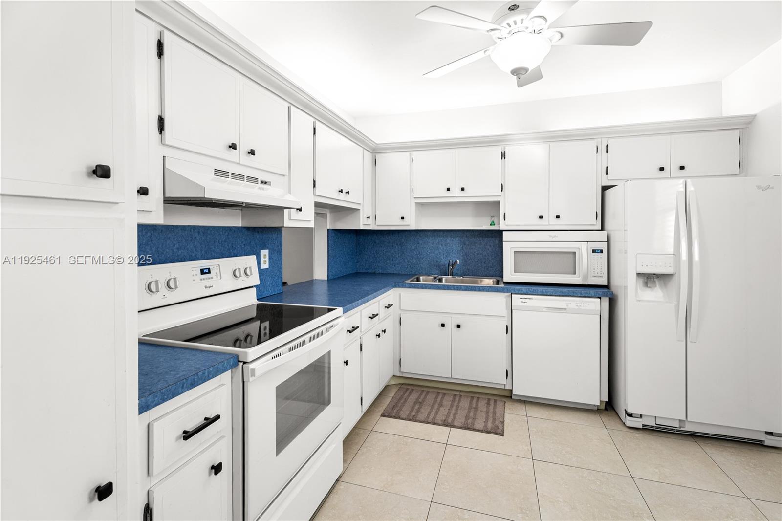 6751 Cypress Road, Unit 207 Plantation, FL 33317 - Photo 4 of 20 a kitchen with cabinets and white appliances