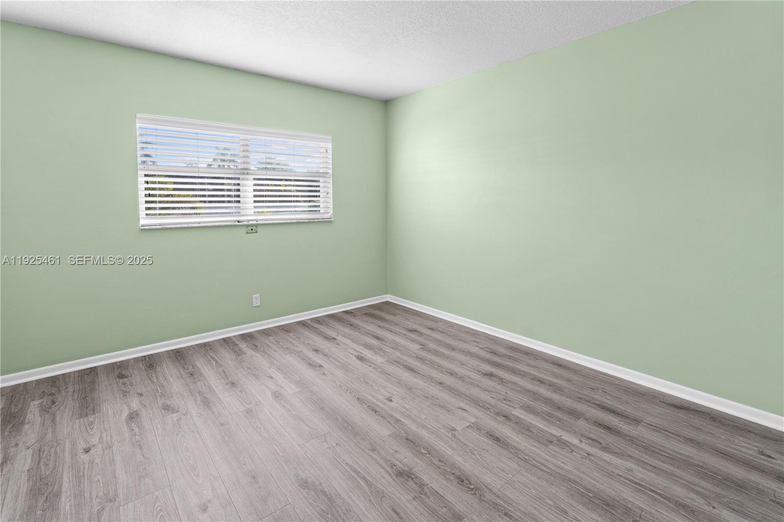 6751 Cypress Road, Unit 207 Plantation, FL 33317 - Photo 10 of 20 a view of a room with wooden floor and windows