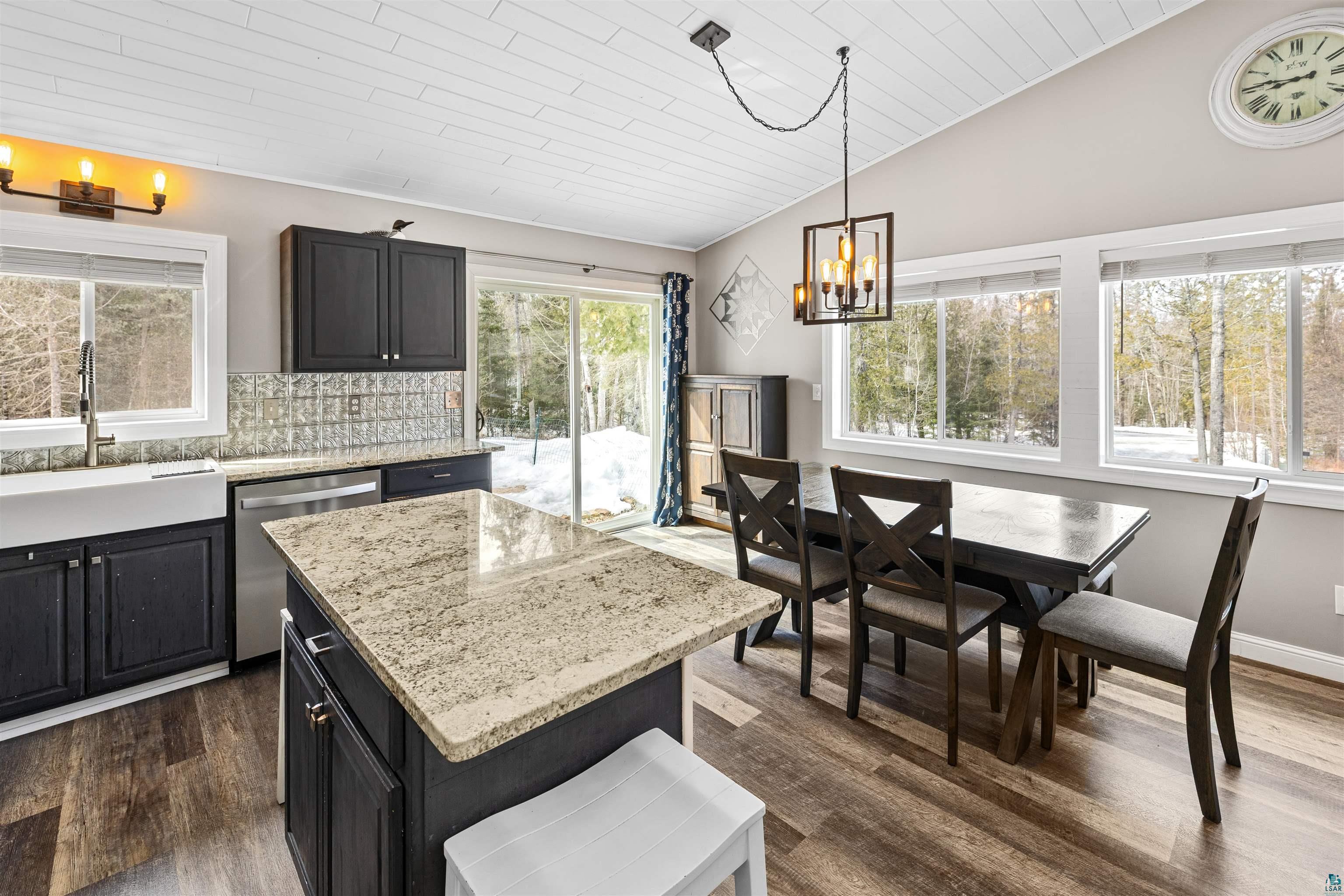13462 Villa Road Ely, MN 55731 - Photo 7 of 68 Kitchen featuring hanging lights, stainless steel dishwasher, a vaulted wood ceiling, a kitchen island, and Lifeproof flooring