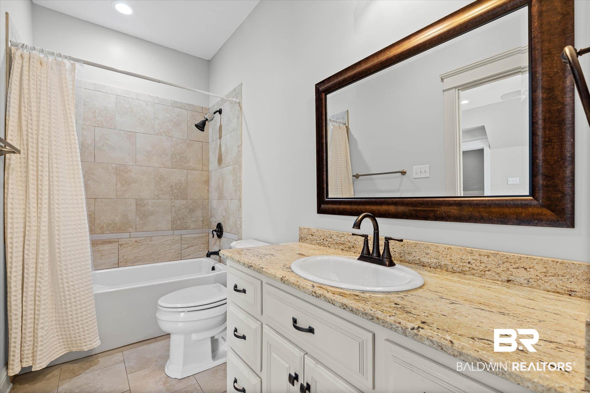 7676 Rockstone Lane Mobile, AL 36695 - Photo 25 of 47 Full bathroom with vanity, shower / bath combo with shower curtain, recessed lighting, and light tile patterned floors
