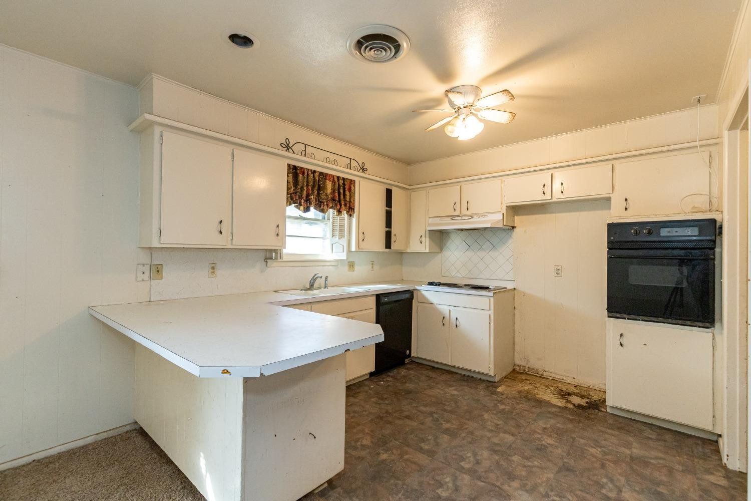 3621 56th Street Lubbock, TX 79413 - Photo 12 of 32 a kitchen with a refrigerator a sink and cabinets