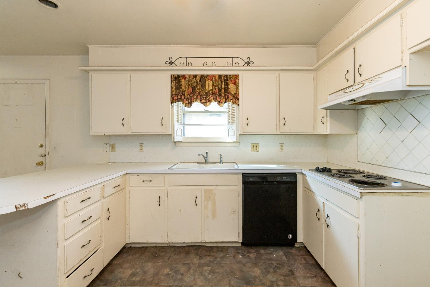 3621 56th Street Lubbock, TX 79413 - Photo 13 of 32 a kitchen with cabinets appliances a sink and a window