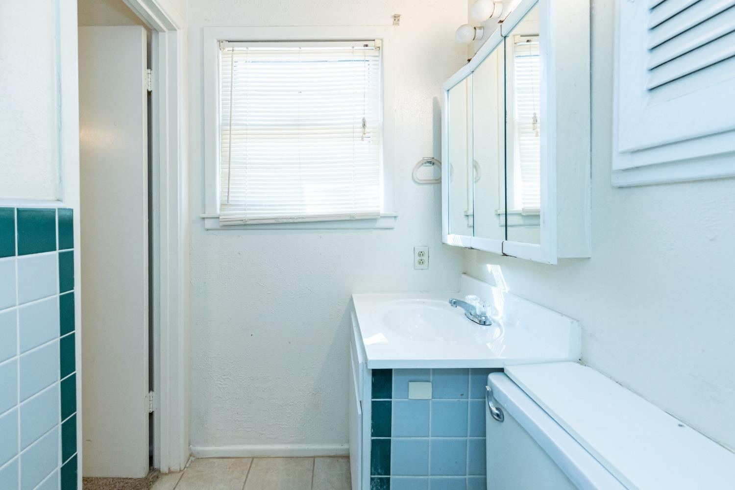 3621 56th Street Lubbock, TX 79413 - Photo 20 of 32 a bathroom with a sink toilet and vanity