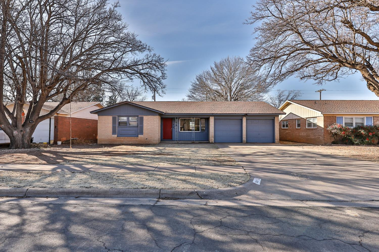 3621 56th Street Lubbock, TX 79413 - Photo 2 of 32 a front view of a house with a garden