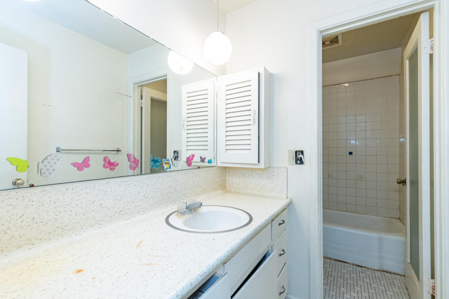 3621 56th Street Lubbock, TX 79413 - Photo 23 of 32 a bathroom with a sink and a mirror