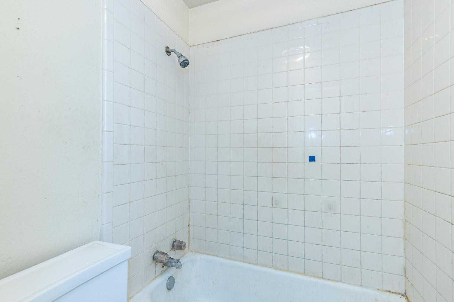 3621 56th Street Lubbock, TX 79413 - Photo 24 of 32 a bathroom with a bathtub and a toilet