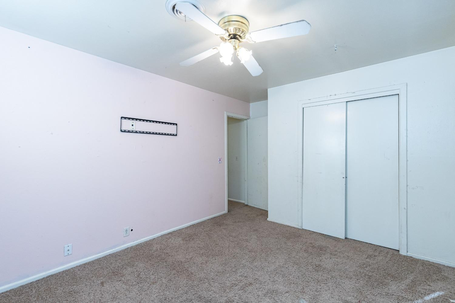 3621 56th Street Lubbock, TX 79413 - Photo 27 of 32 an empty room with closet and a chandelier fan