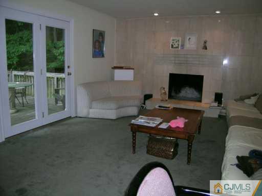 21 Navajo Road East Brunswick, NJ 08816 - Photo 6 of 8 a living room with furniture and a fireplace