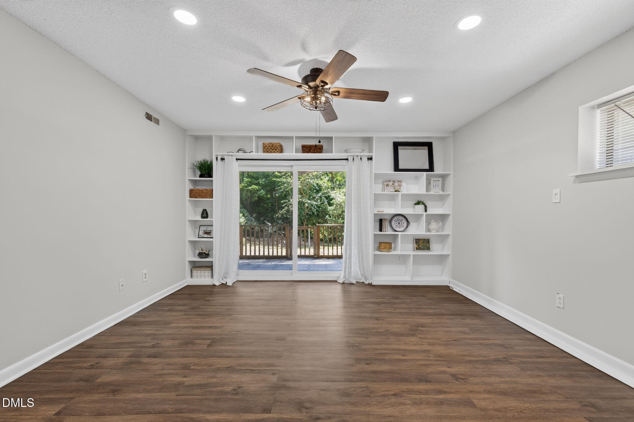 546 Pine Ridge Place Raleigh, NC 27609 - Photo 3 of 21 a view of an empty room with a window and wooden floor