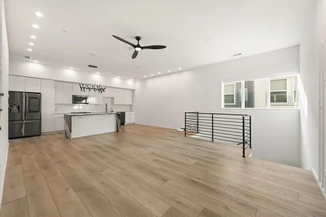 a view of kitchen with refrigerator microwave and stove