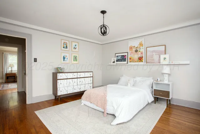 a bedroom with a large bed and a window