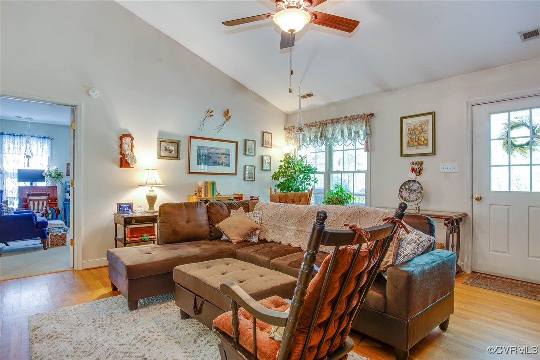 3875 Wakema Road West Point, VA 23181 - Photo 11 of 45 a living room with furniture a chandelier and a window