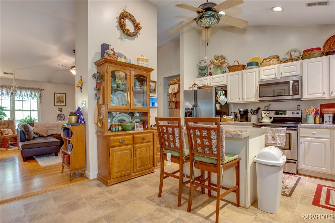 3875 Wakema Road West Point, VA 23181 - Photo 16 of 45 a kitchen with stainless steel appliances granite countertop a refrigerator and a stove top oven