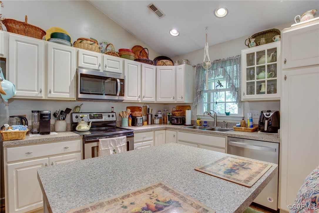 3875 Wakema Road West Point, VA 23181 - Photo 18 of 45 a kitchen with stainless steel appliances granite countertop a stove top oven a sink a refrigerator and cabinets