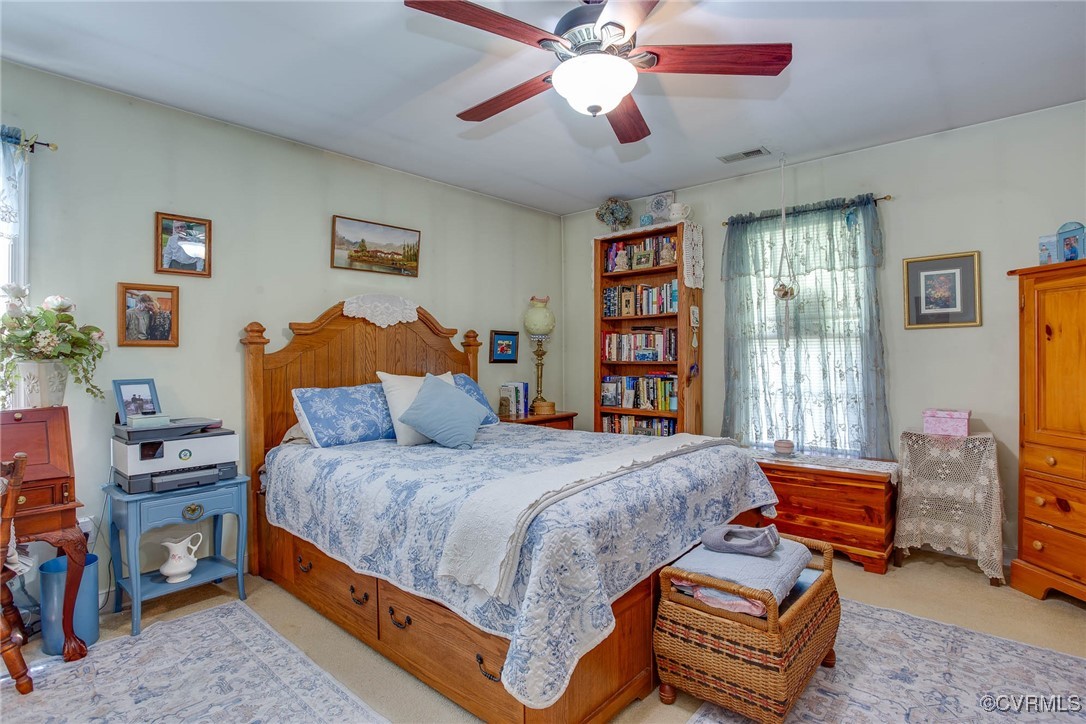 3875 Wakema Road West Point, VA 23181 - Photo 24 of 45 a bedroom with a bed and a chandelier